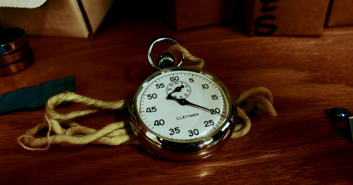 A classic stopwatch on a wooden table